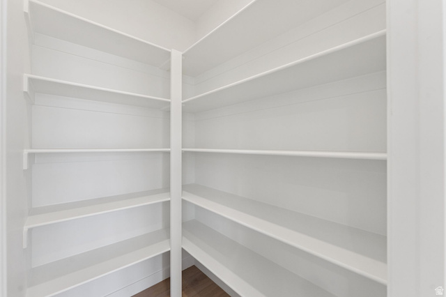 1004 West Paramount Cove South, Unit 315 Ogden, UT 84405 - Photo 12 of 42 Spacious pantry featuring multiple tiers of white shelving and wood-finish flooring