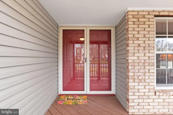 a kitchen with white cabinets and sink