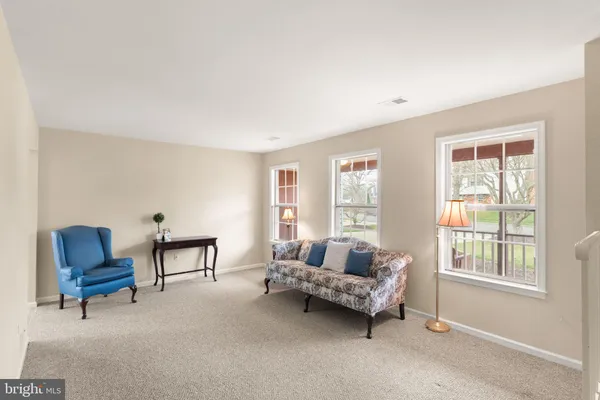 an empty room with windows and chandelier