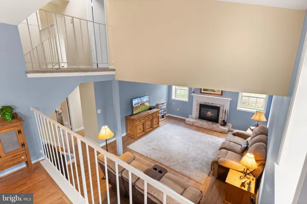 a view of staircase with railing and white walls