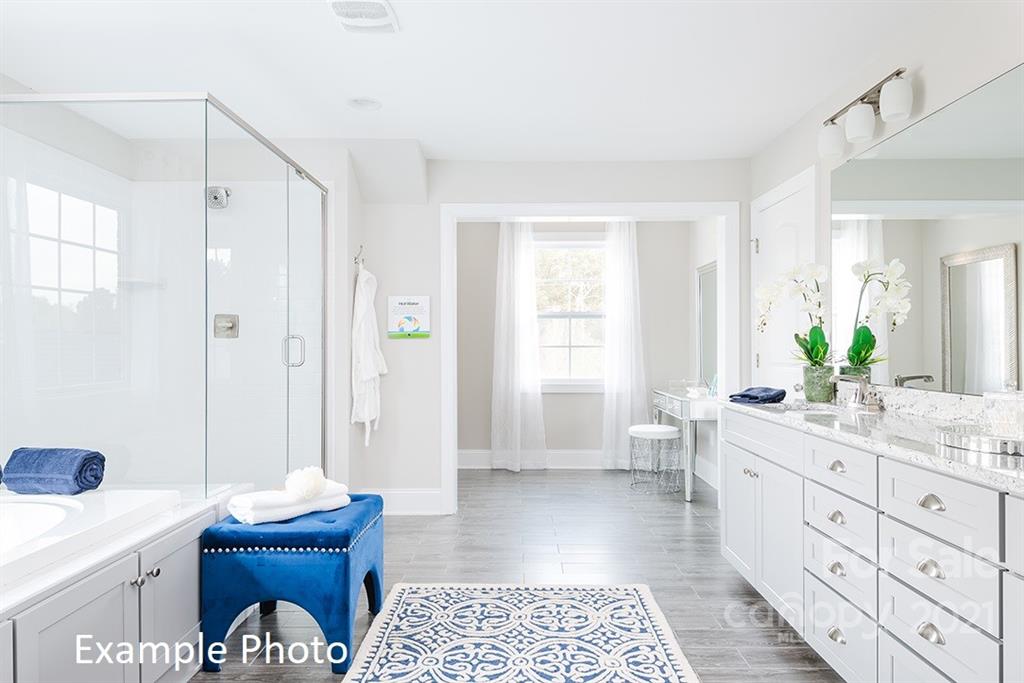 5168 Mill Creek Road, Unit 2 Clover, SC 29710 - Photo 2 of 3 a spacious bathroom with a double vanity sink a mirror and a shower