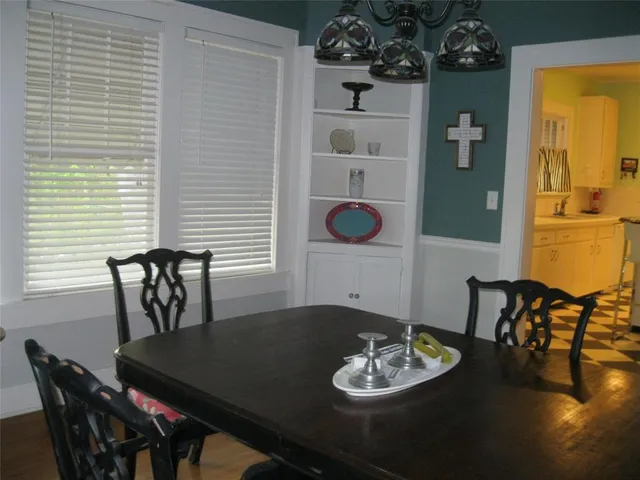 a dining room with furniture and window
