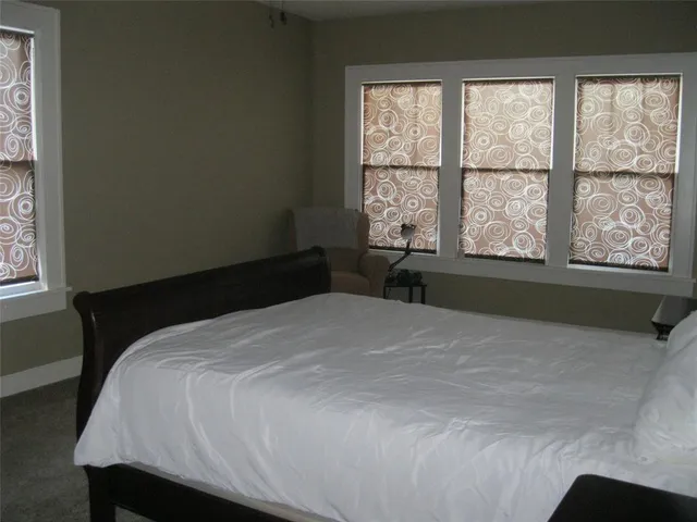 a bedroom with furniture and windows
