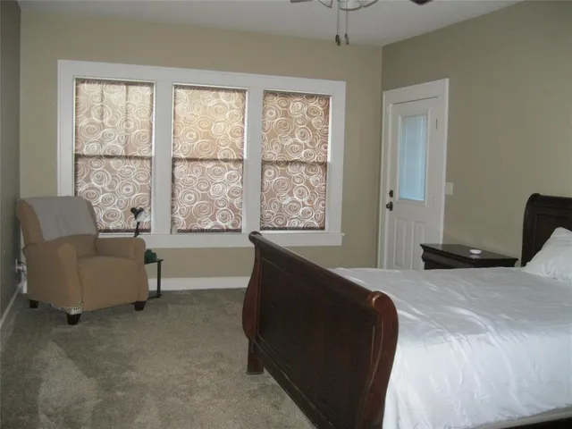 a bedroom with bed and a dresser