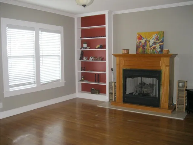 a living room with a fireplace and a window