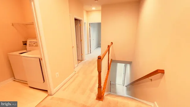 a view of a staircase with white walls