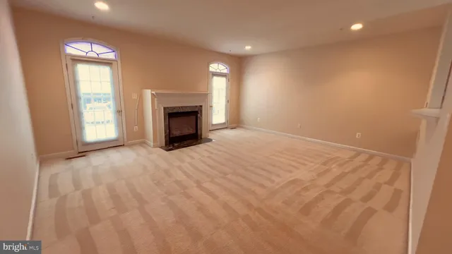 a view of empty room with a fireplace