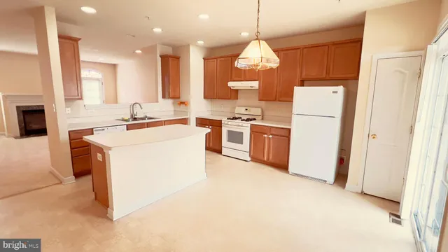 a kitchen with a stove a sink and a refrigerator