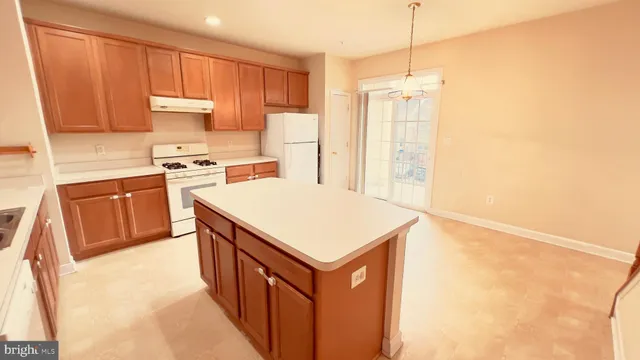 a kitchen with stainless steel appliances granite countertop a stove a refrigerator a sink and dishwasher