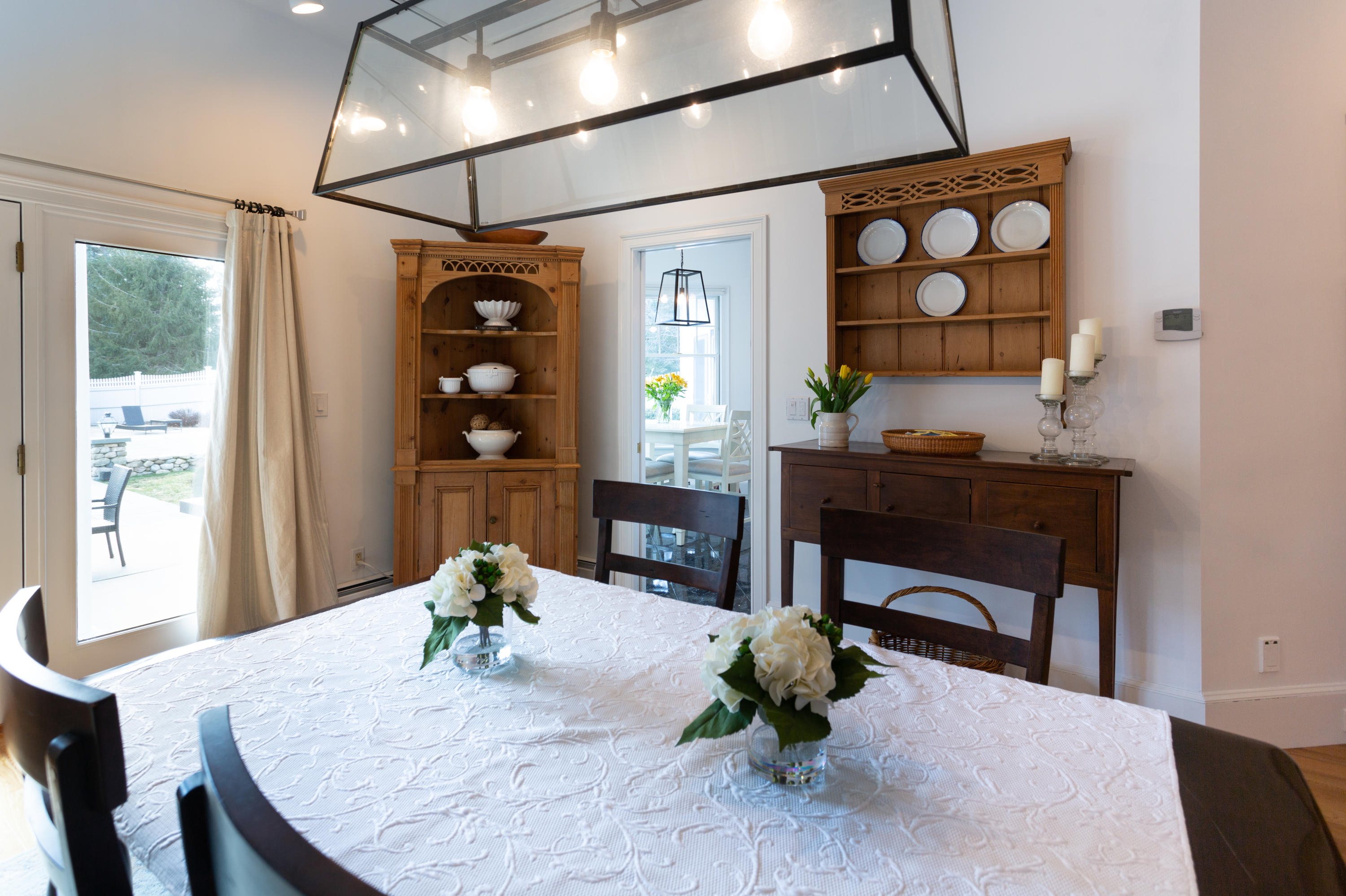 155 Baxter Neck Road Marstons Mills, MA 02648 - Photo 8 of 41 a dining room with wooden floor a chandelier a wooden table and chairs