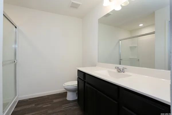 a bathroom with a sink a toilet a mirror and vanity