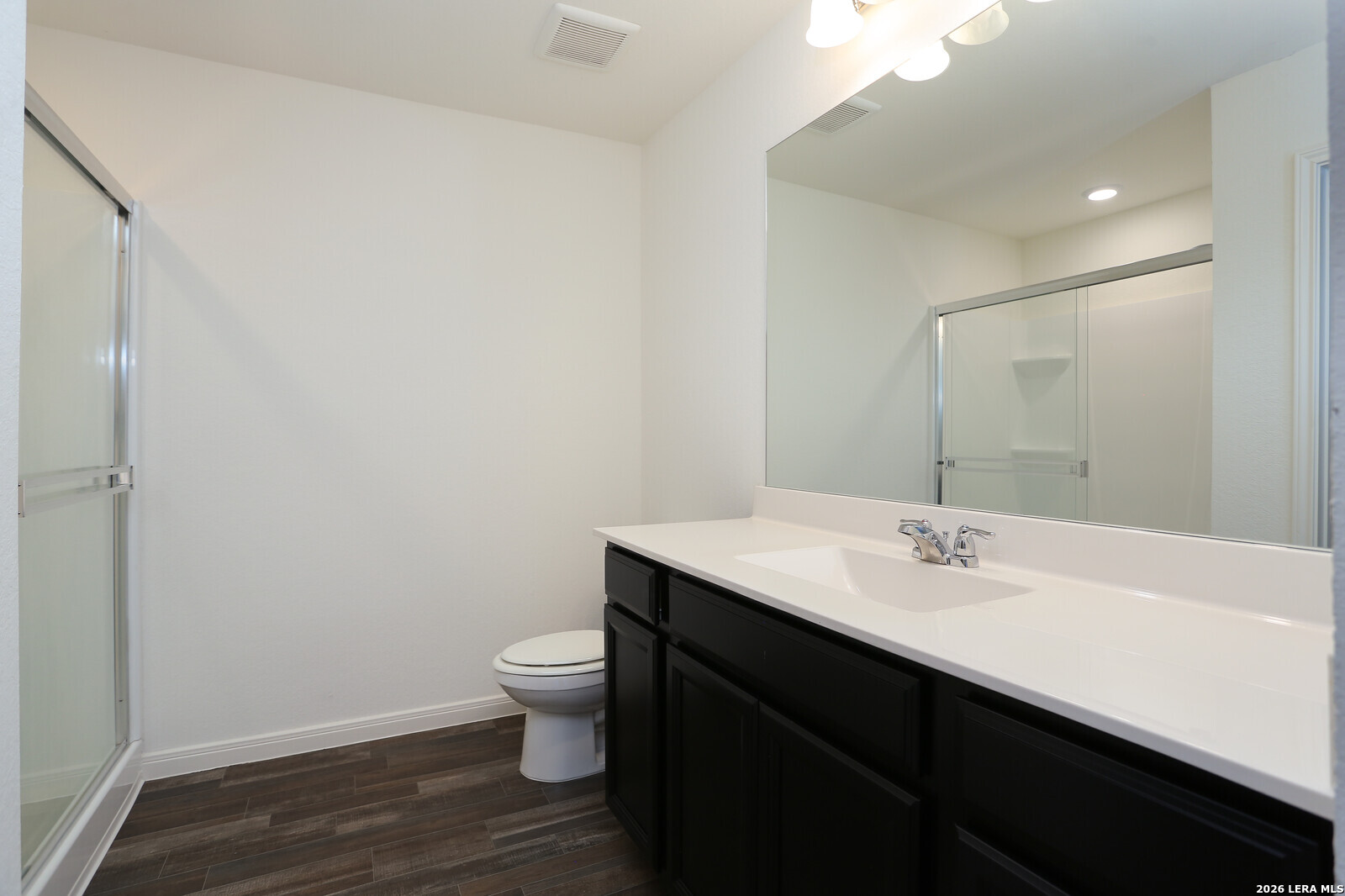 4913 Hallies Garden St. Hedwig, TX 78152 - Photo 12 of 23 a bathroom with a sink a toilet a mirror and vanity