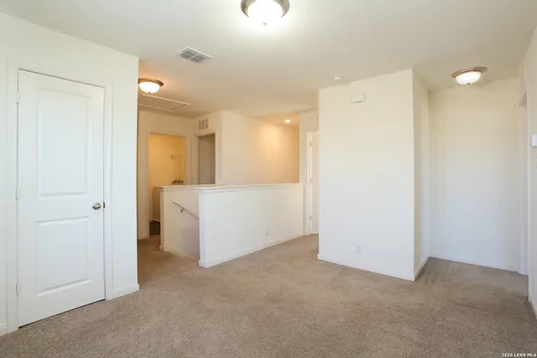 a view of a storage & utility room with a fridge
