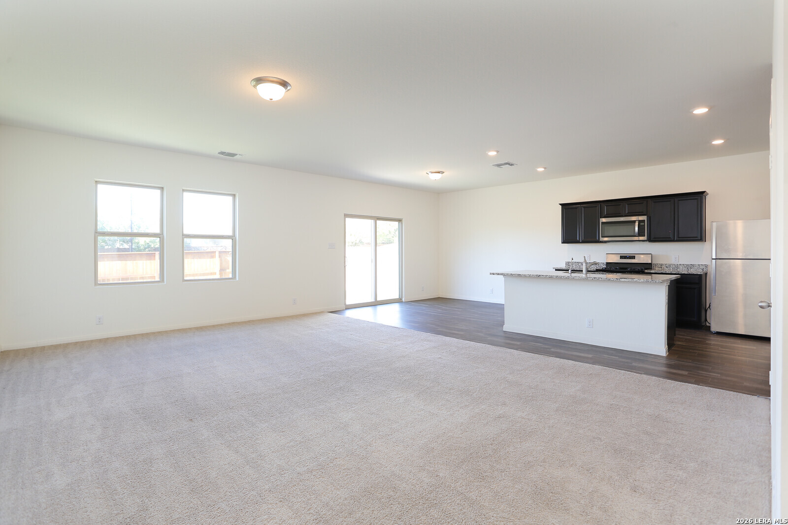 4913 Hallies Garden St. Hedwig, TX 78152 - Photo 3 of 23 a view of a kitchen with a sink microwave and cabinets