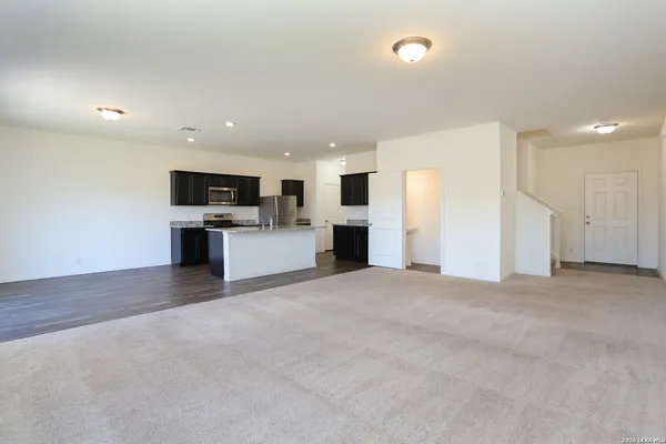 a view of a kitchen with a sink and a refrigerator