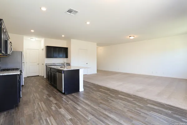 a large kitchen with a large counter top appliances and cabinets