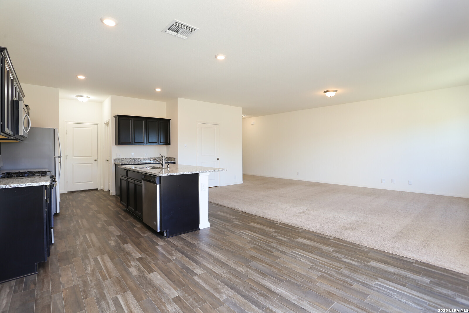 4913 Hallies Garden St. Hedwig, TX 78152 - Photo 7 of 23 a large kitchen with a large counter top appliances and cabinets