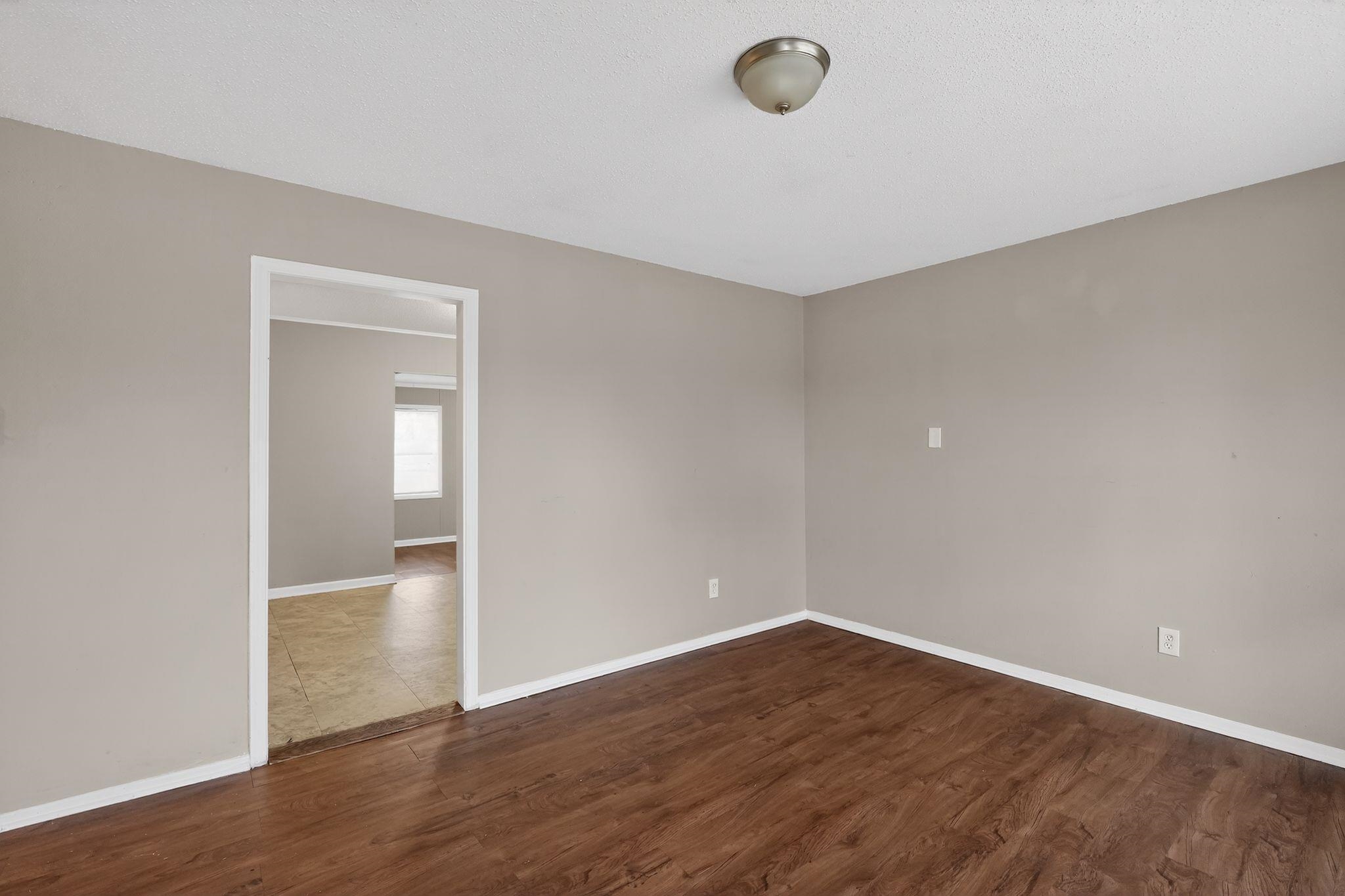 4314 Ford Road Memphis, TN 38109 - Photo 16 of 31 a view of an empty room with wooden floor