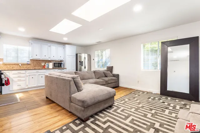 a living room with furniture and kitchen view