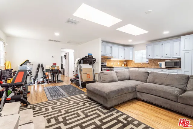 a living room with furniture and kitchen view