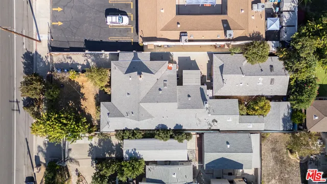 an aerial view of a house with a yard and large trees