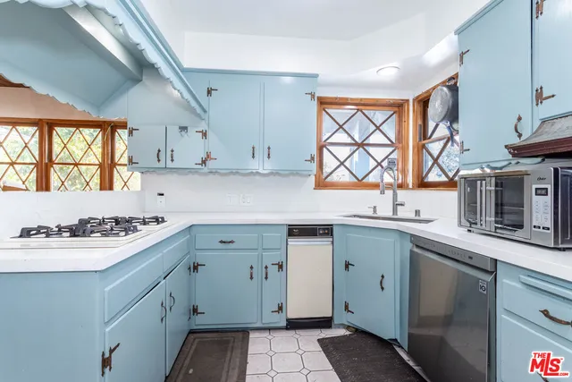 a kitchen with a sink stove and cabinets