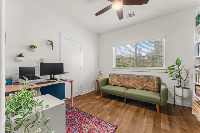 a living room with a couch and a potted plant