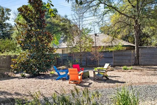 a view of a park with iron fence