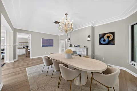 a living room with fireplace furniture and a chandelier
