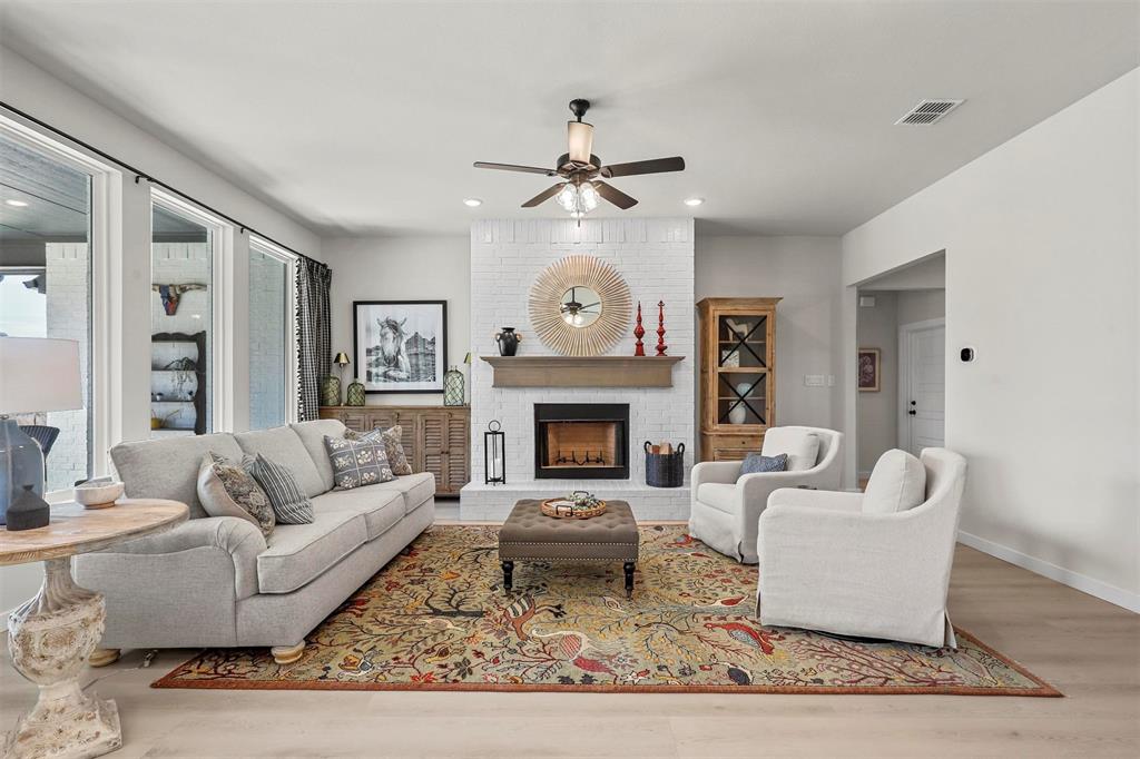 147 Rj Smith Drive Boyd, TX 76023 - Photo 8 of 15 a living room with furniture a rug and a fireplace