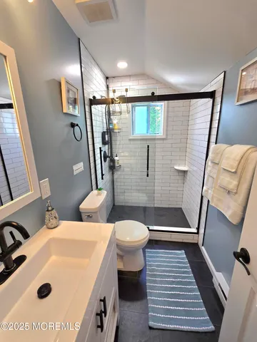 a bathroom with a sink toilet and shower