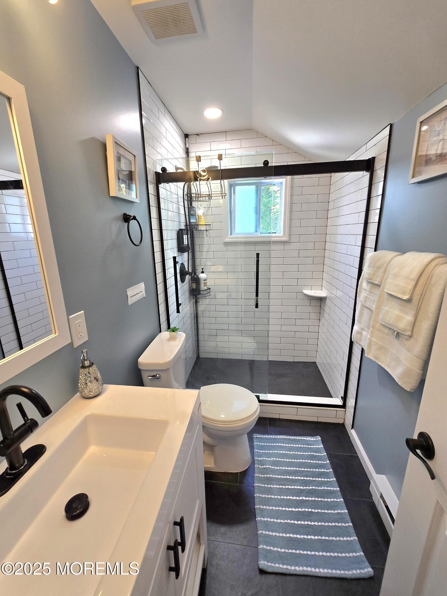 406 4th Avenue, Unit REAR COTTAGE Asbury Park, NJ 07712 - Photo 4 of 5 a bathroom with a sink toilet and shower