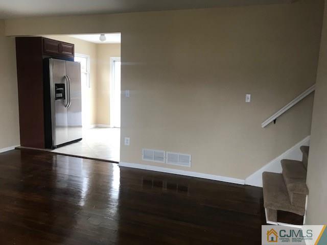 218 McFarlane Road Colonia, NJ 07067 - Photo 3 of 18 a view of an empty room with wooden floor