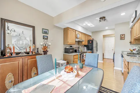 a living room with furniture kitchen view and a large window