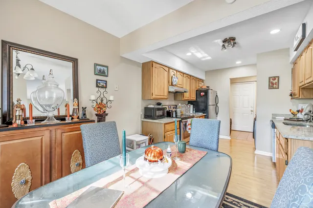 a living room with furniture kitchen view and a large window