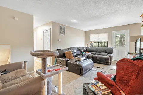 a living room with furniture a mirror and a window