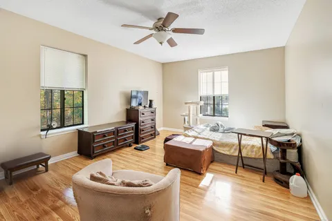 a living room with furniture and a wooden floor