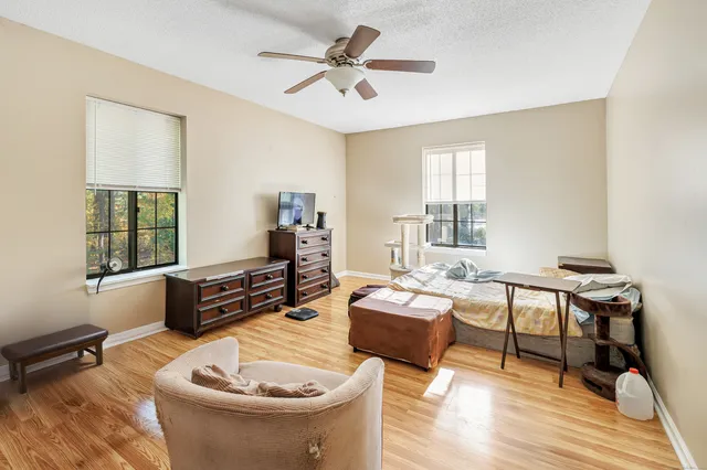 a living room with furniture and a wooden floor