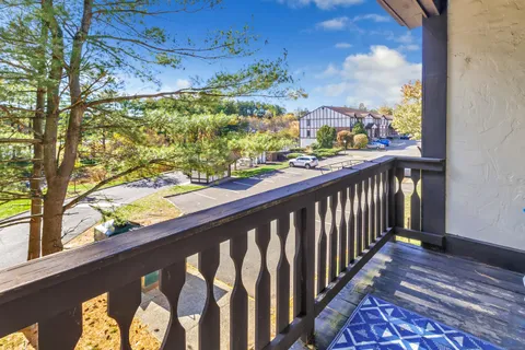 a view of a balcony with wooden floor