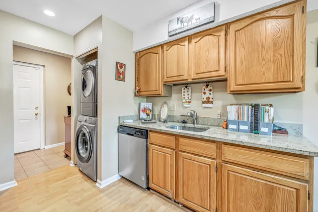 a kitchen with stainless steel appliances granite countertop a sink and a white cabinets