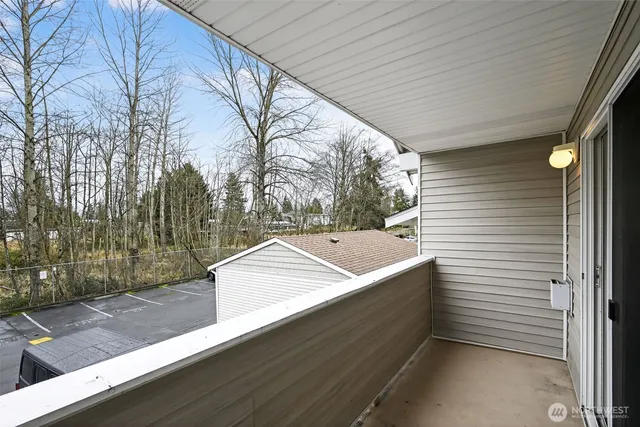 a view of a patio with table and chairs couches under an umbrella
