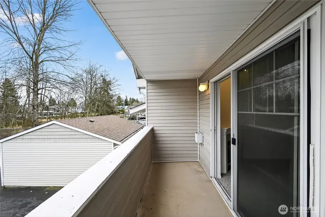 a view of a street with potted plants and a building