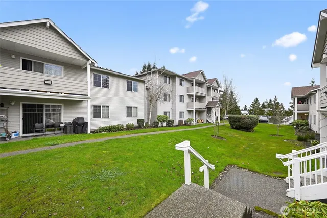 a view of a house with a yard and deck