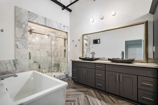 a bathroom with a granite countertop sink a toilet and shower