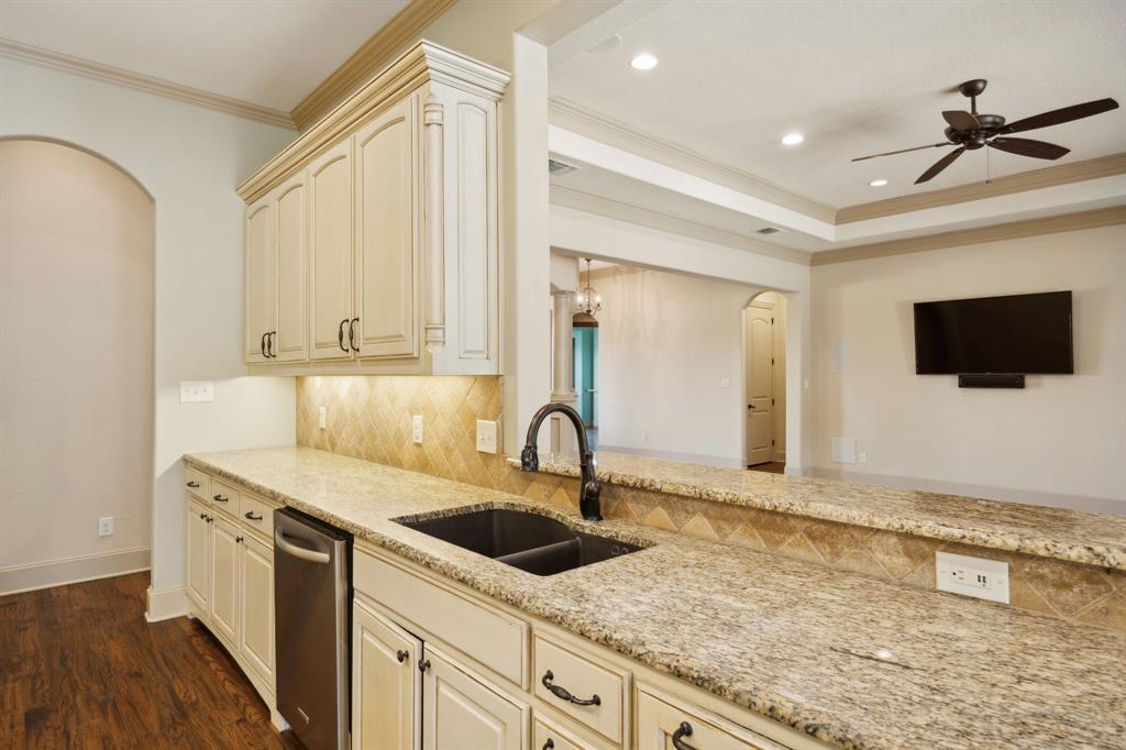 301 Harrison Circle Van Alstyne, TX 75495 - Photo 17 of 38 a kitchen with stainless steel appliances granite countertop a sink and a microwave