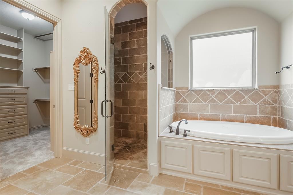 301 Harrison Circle Van Alstyne, TX 75495 - Photo 22 of 38 a bathroom with a bathtub and a shower