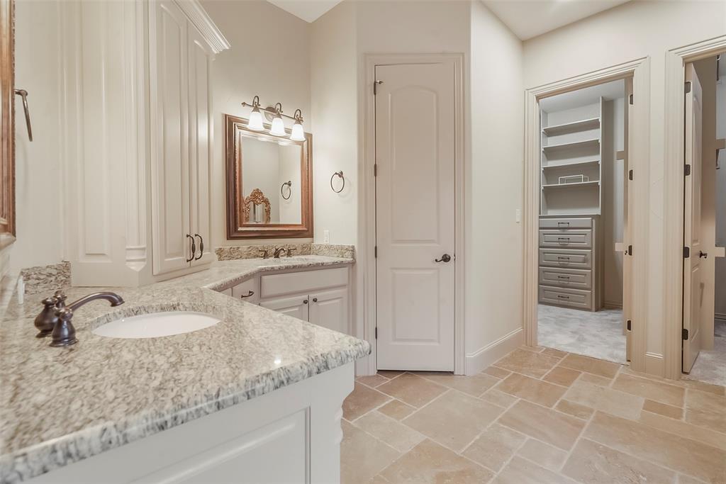 301 Harrison Circle Van Alstyne, TX 75495 - Photo 23 of 38 a bathroom with a granite countertop sink and a mirror