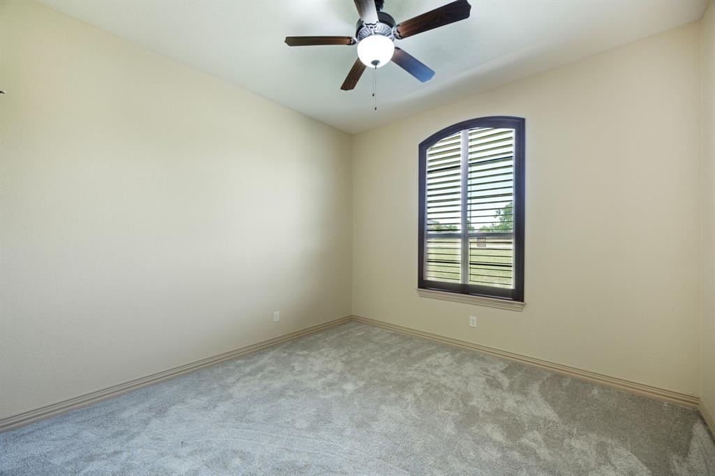 301 Harrison Circle Van Alstyne, TX 75495 - Photo 29 of 38 an empty room with windows and fan