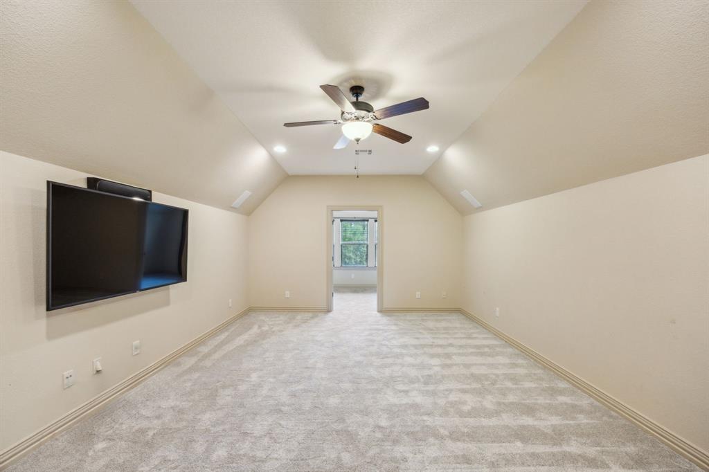 301 Harrison Circle Van Alstyne, TX 75495 - Photo 34 of 38 an empty room with a flat screen tv and a ceiling fan