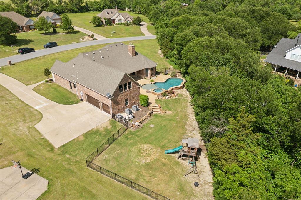 301 Harrison Circle Van Alstyne, TX 75495 - Photo 7 of 38 a view of a swimming pool with a yard